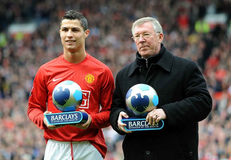 Cristiano Ronaldo and Sir Alex Ferguson receive trophies during their time at Manchester United