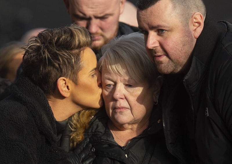 Lurgan murder victim Odhrán Kelly's mother Jacqueline (centre) is comforted by family at his funeral on Sunday. Picture by Mark Marlow.  