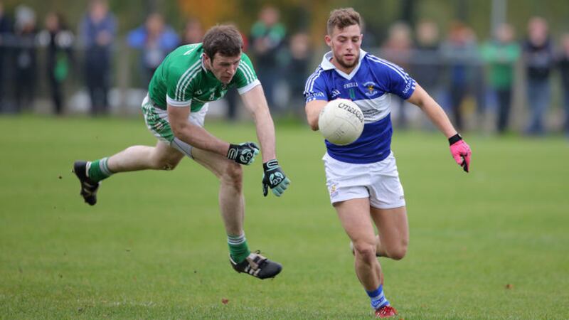 OUT IN FRONT: Conor Johnston of St John&rsquo;s gets away from Cargin&rsquo;s Justin Crozier during yesterday&rsquo;s Antrim SFC semi-final replay in Glenavy <br />													   Picture: Cliff Donaldson&nbsp;