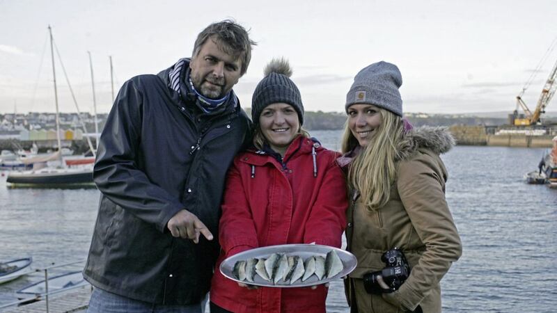 TV presenters Xavier Petit (left) and Laurie Medina (right) with Wendy Gallagher, Causeway Coast Foodie Tours, and their catch at Portrush Harbour. 