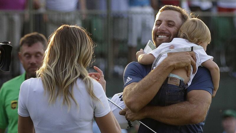 &nbsp;Johnson greets his fiance Paulina Gretzky as he holds their son Tatum on the 18th green.&nbsp;Picture by PA
