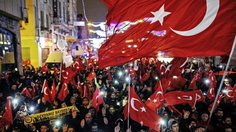 Protesters wave flags outside the Dutch consulate in central Istanbul on Sunday. Picture by Emrah Gurel, Associated Press 