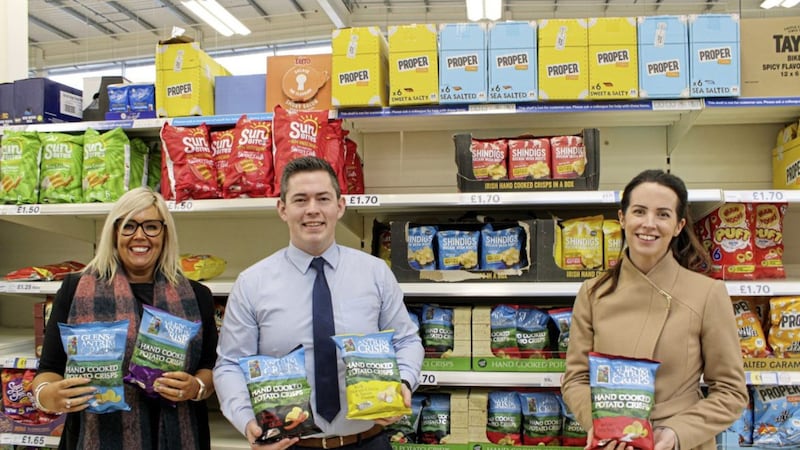 Tesco&#39;s Michael Crealey (centre) with Mary McKillop (left) and Amy Stewart (right) from Glens of Antrim Crisps. 