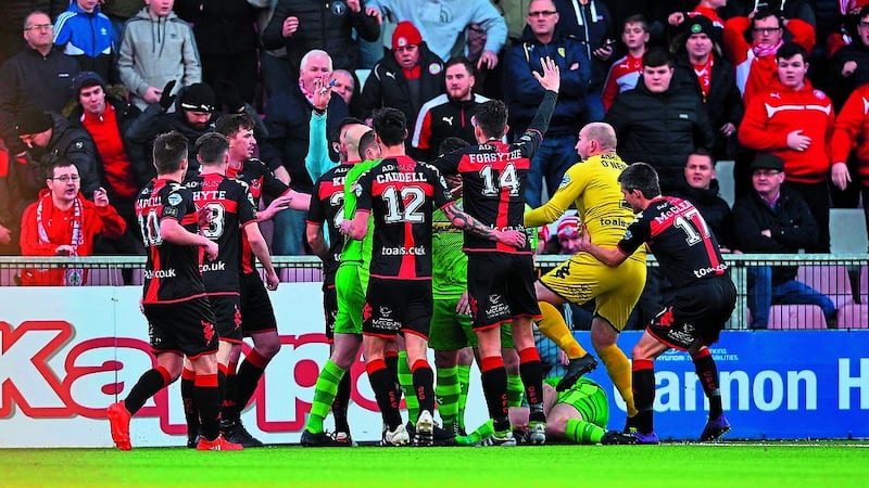 <strong>&nbsp;BAD BREAK: </strong>Crusaders goalkeeper Sean O&rsquo;Neill rushes to remonstrate with the referee after Cliftonville midfielder Ryan Catney&rsquo;s first half tackle with Crues&rsquo; defender Howard Beverland during Saturday&rsquo;s north Belfast derby at Seaview. Catney received a red card as he was stretchered off with a broken leg, with a Michael Carvill goal after the interval consolidating the Hatchetmen&rsquo;s lead at the top of the Danske Bank Premiership. Picture by Pacemaker