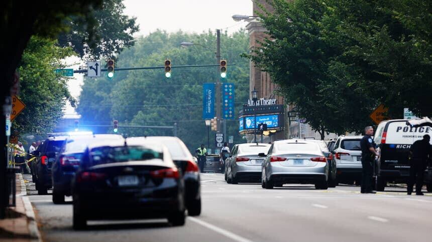 Cars and police gather around Altria Theater, the site of a shooting at the Huguenot High School graduation, Tuesday, June 6, 2023, in Richmond, Va. (Mike Kropf/Richmond Times-Dispatch via AP)