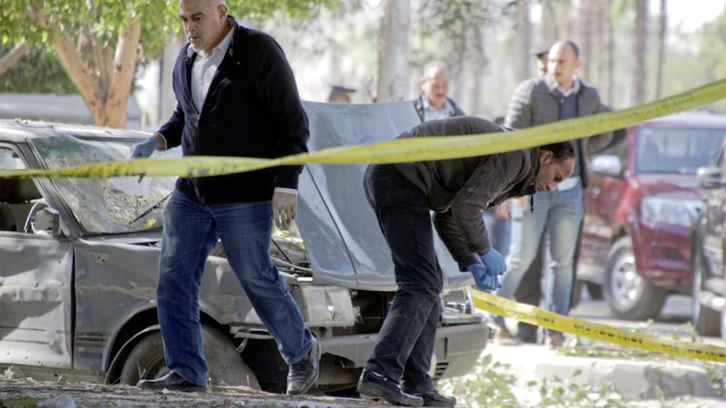 Egyptian explosions experts look for evidence at the site of the explosion. Picture by Amr Nabil, Associated Press