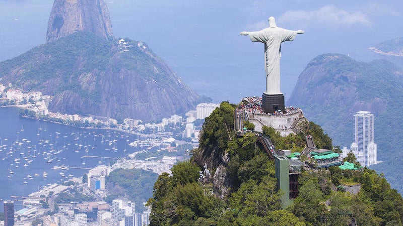 The statue of Christ Redeemer overlooks Rio, with Sugarloaf Mountain in the background 