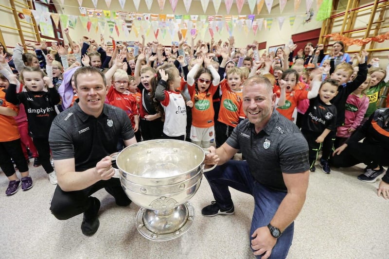 Jason McGahan and Colin Trainor with the children of Our Lady&#39;s Primary School, Tullysaran yesterday Picture: Hugh Russell 