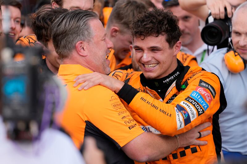 McLaren CEO Zak Brown, left, hugs Norris after the race (Rebecca Blackwell/AP)