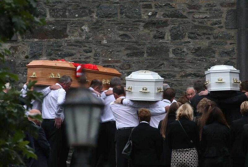 Coffins are taken into Saint Mary's Church in Castlerahan, Co Cavan, where the funeral of the Hawe family was held. Picture by Brian Lawless, Press Association