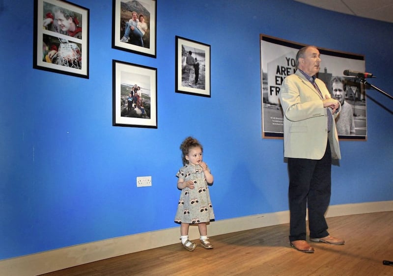 Little Sadhbh McGuinness (2), grandaughter of the late Martin McGuinness, toddles by as Mitchel McLaughlin addresses the official opening of the exhibition &#39;Martin&#39; at the Gasyard centre in Derry&#39;s Bogside on Wednesday. The photographic exhibition, curated by the McGuinness Family chronicles his remarkable life including images from the family&#39;s private collection. Picture Margaret McLaughlin 9-8-17. 