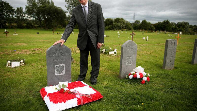 Honorary Polish Consul Jerome Mullen at the graves of seven Polish airmen, killed during the Second World War, at Milltown Cemetery 