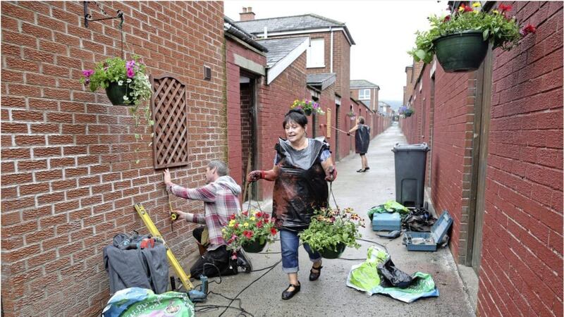 Work on the alleyway gets underway as part of the Ardoyne &amp; Marrowbone community festival. Picture by Hugh Russell 