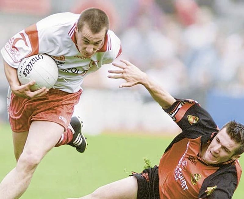 Brian McGuigan holds off Down&#39;s Ronan Murtagh during the 2003 Ulster final 
