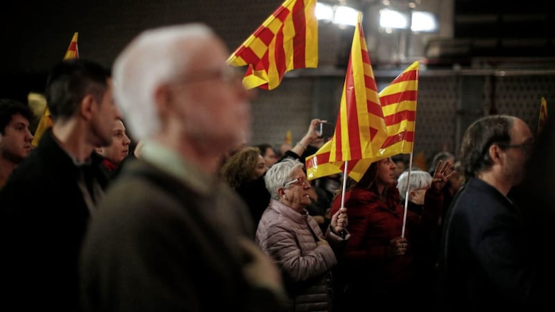 Supporters wave Catalonia flags during an event of the political platform &#39;Junts per Catalunya&#39; to mark the official start of the electoral campaign for the Catalan regional election in Barcelona PICTURE: Manu Fernandez/AP 