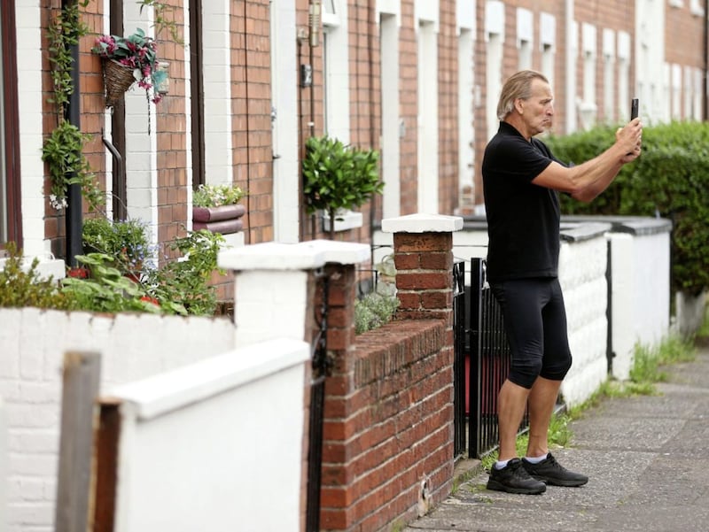 Actor Christopher Eccleston pictured while out jogging in Belfast , visiting Van Morrions childhood home in Hyndford Street and Cyrus Avenue, George Bests home, and Alex Higgins also Picture Mal McCann. 