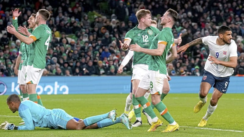 Republic of Ireland players appear dejected after Norway&#39;s Ohi Omoijuanfo (right) scores the winner in Dublin last night 
