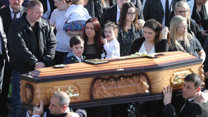 Joanne McGibbon and her children at the funeral of her husband Michael in north Belfast. Picture by Hugh Russell.