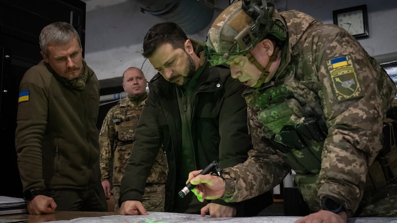 Ukrainian President Volodymyr Zelensky and Gen Oleksandr Syrski, look at a map during their visit to the front line city of Kupiansk, Kharkiv regionin November (Efrem Lukatsky/AP)