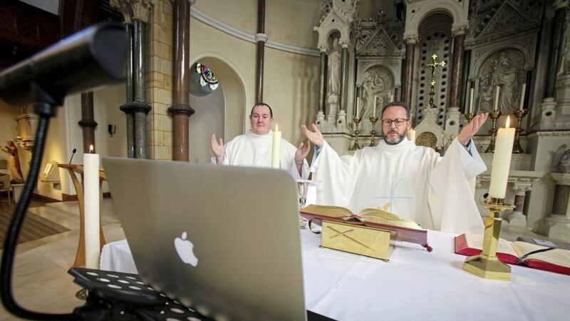 Fr Eugene O&#39;Neill and Fr Tony McAleese celebrate mass on Easter Sunday and broadcast on Facebook in St Patrick&#39;s Church Donegall Street. Picture by Mal McCann 