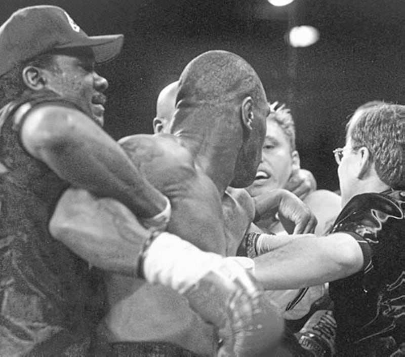 HOLD ME BACK...Mike Tyson and Francois Botha are pulled apart after they continued to fight following the bell in the first round of Saturday&rsquo;s heavyweight fight in Las Vegas 