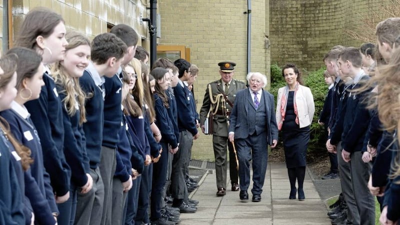 President Michael D. Higgins, pictured with Mulroy College principal, Fiona Temple, was given a guard of honour by friends and classmates of Creeslough tragedy victims, James Monaghan and Leona Harper, when he visited the school on Friday. Photo Clive Wasson 