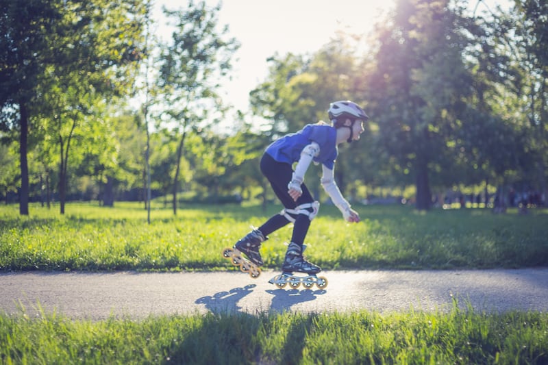 Boy riding roller skates in park