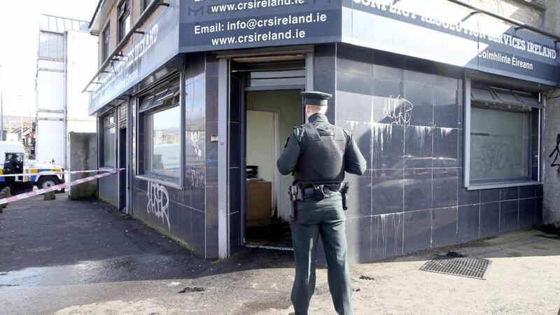 Police and forensic officers at the scene of a suspected arson attack in west Belfast at the Conflict Resolution Services Ireland premises on the Falls Road. Picture by Mal McCann. 