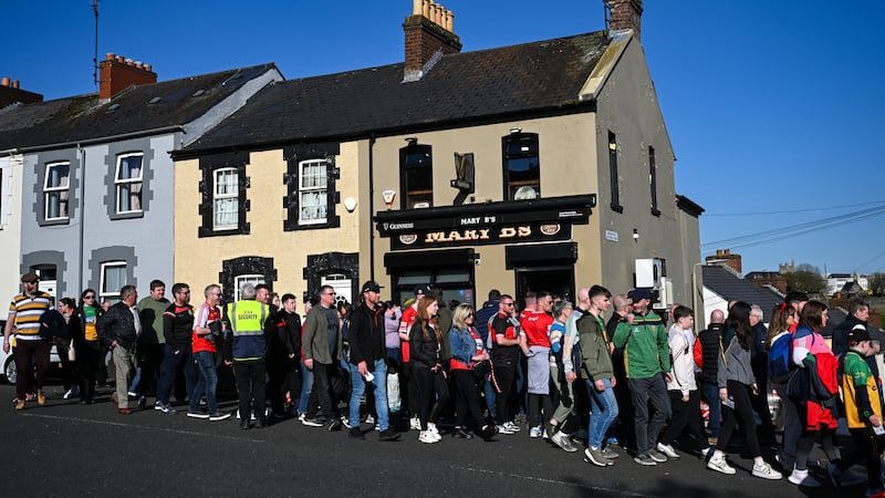 The crowd makes its way past Mary B's bar right beneath Bligh's Lane, a place that has seen such innocence and such terror in the shadow of Celtic Park. Photo: Stephen McCarthy/Sportsfile