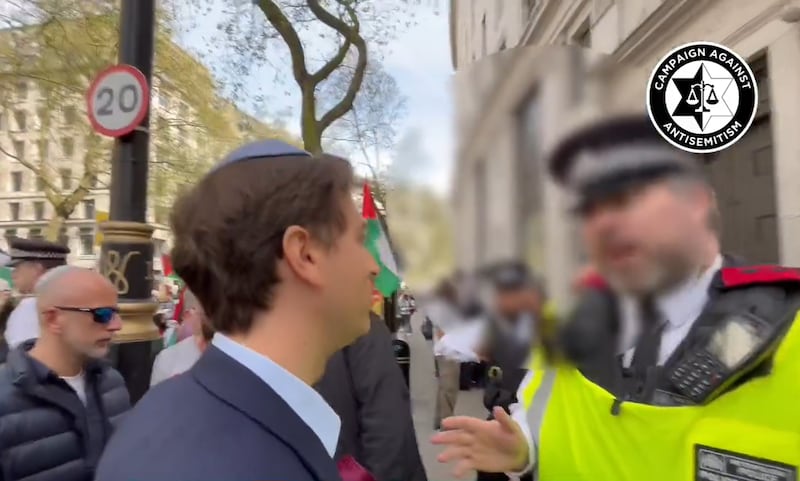 Campaign Against Antisemitism chief executive Gideon Falter speaking to a Metropolitan Police officer