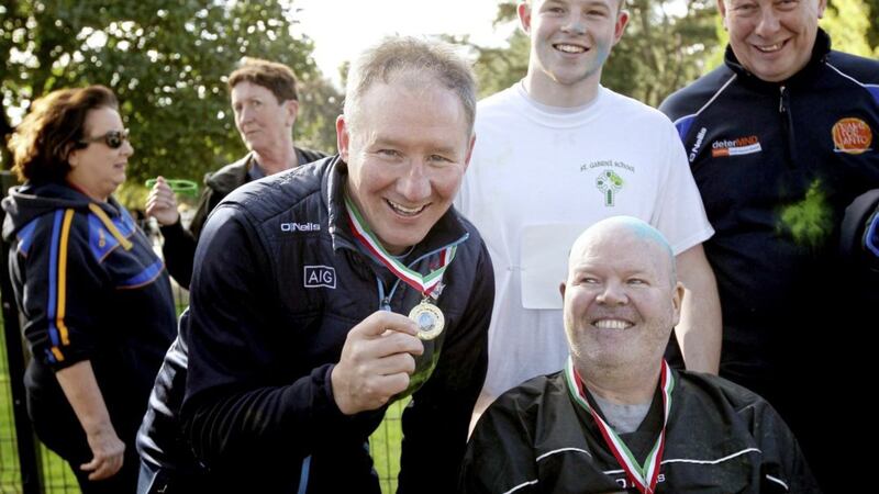 Dublin manager Jim Gavin shows Anto Finnegan his medal for completing the Run For Anto event in Falls Park last Sunday. The proceeds of the colour run are going to deterMND Picture by Ann McManus 