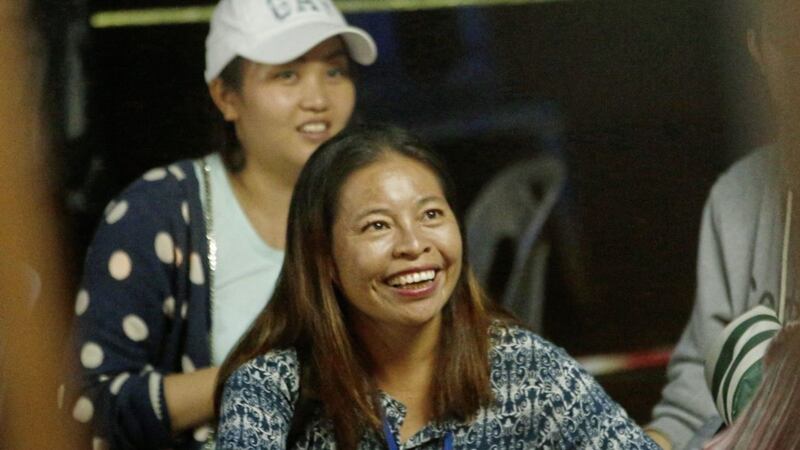 A family member smiles after hearing the news that the missing 12 boys and their soccer coach have been found PICTURE: Sakchai Lalit 