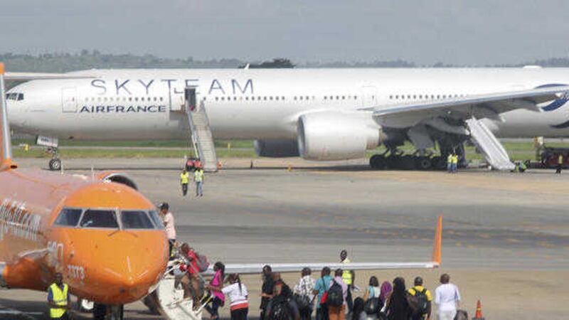 EMERGENCY: An Air France plane which made an emergency landing is seen behind passengers boarding a small jetliner at Moi International Airport in Mombasa, Kenya yesterday PICTURE: Edwin Kana/AP 