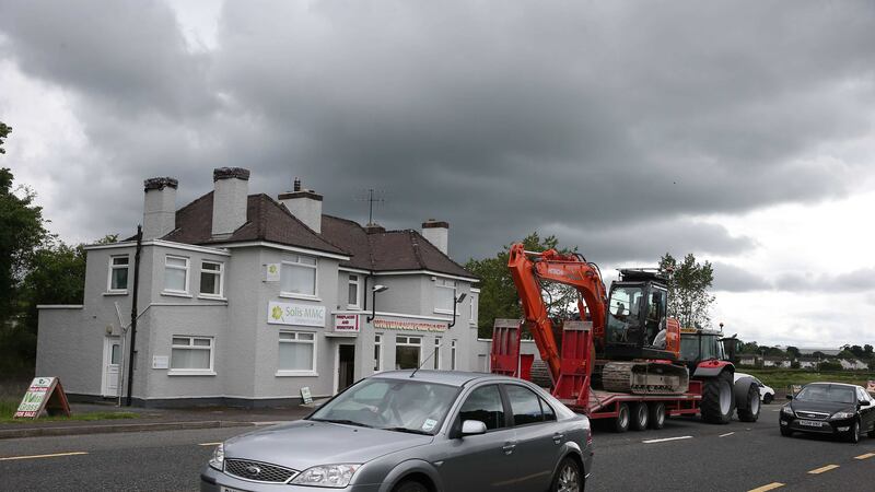Traffic passes the building which once housed a customs post in the village of Bridgend, Co Donegal, on the border. Picture by Brian Lawless, Press Association&nbsp;