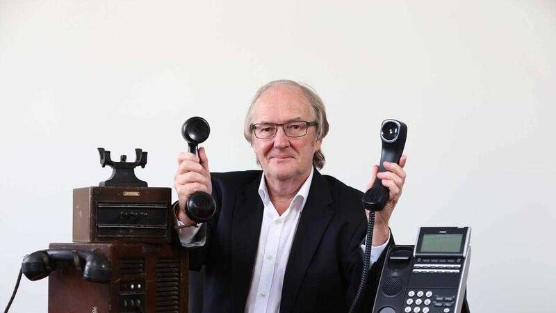 ERIC DIALS UP 50 YEARS IN BUSINESS . . . Eric Carson shows how phones have changed in the last half century 