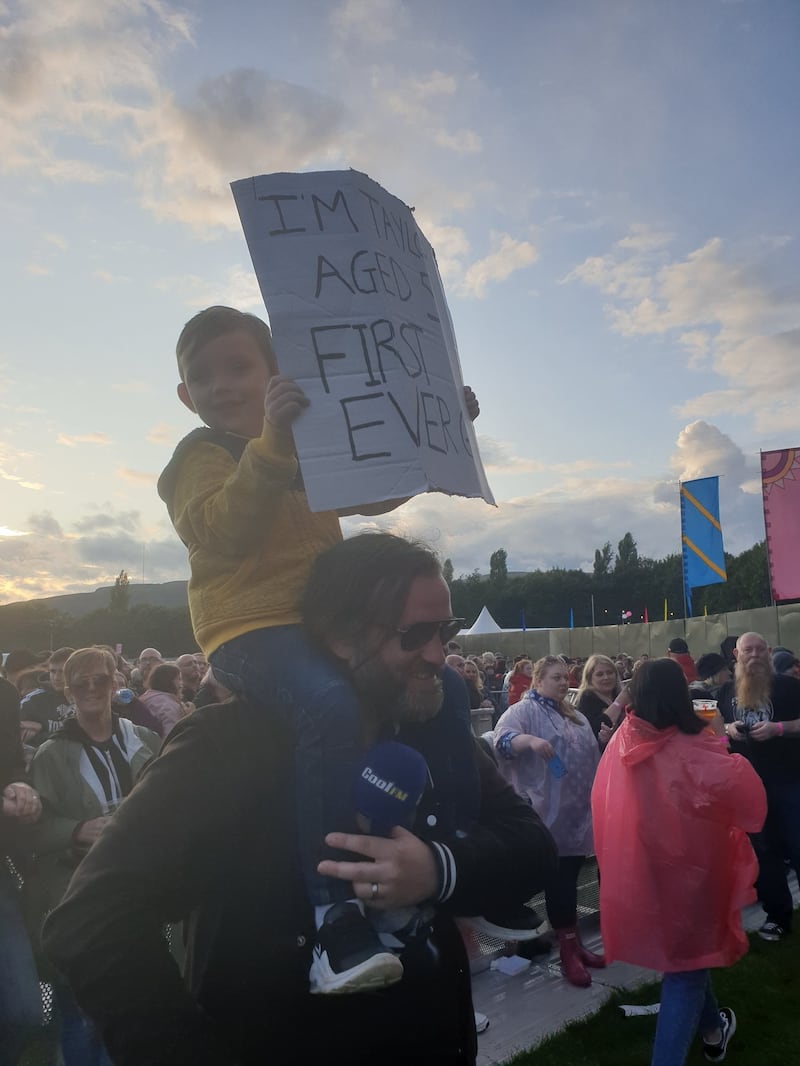 Taylor Blackburn, 5, holds a sign up that reads 'I'm Taylor Aged 5 First Ever Gig'