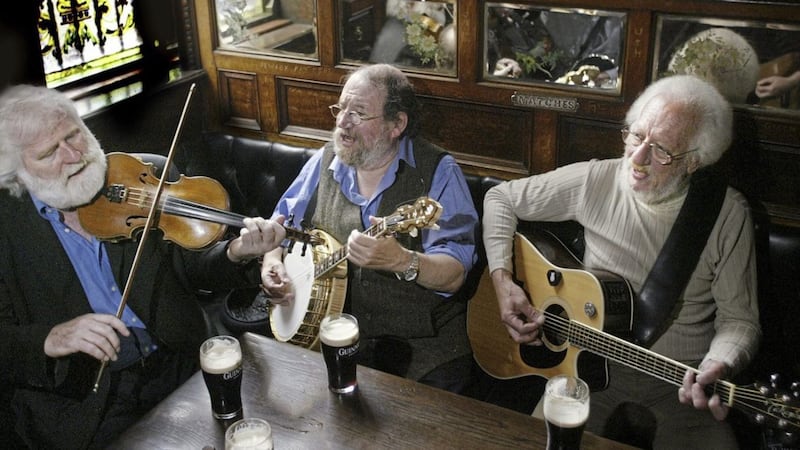 Eamonn Campbell, right, pictured with members of the Dubliners in the Crown Bar in Belfast in 2012. Picture by Hugh Russell  