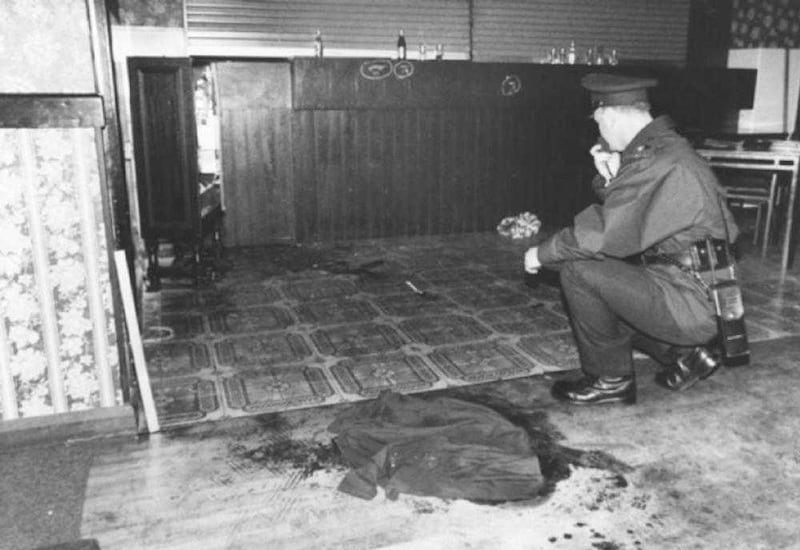 A police officer surveys the scene of carnage at the Rising Sun bar. 