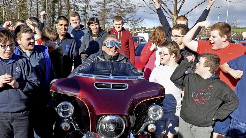 Children from Tor Bank School cheer on principal Colm Davis as he is surprised by Harley Davidson bikers 