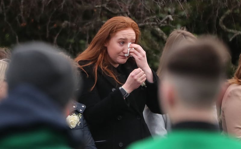 A mourner wipes her eyes during the funeral of siblings Conor, Darragh and Carla McGinley at the Church of the Holy Family in Rathcoole, Dublin. Picture by Niall Carson/PA Wire&nbsp;
