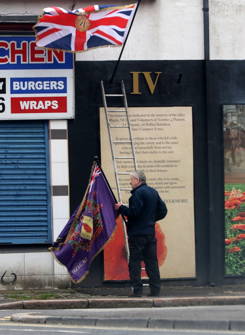 Shankill Butcher Eddie McIlwaine erecting flags in Glenwood Street off the Shankill Road 