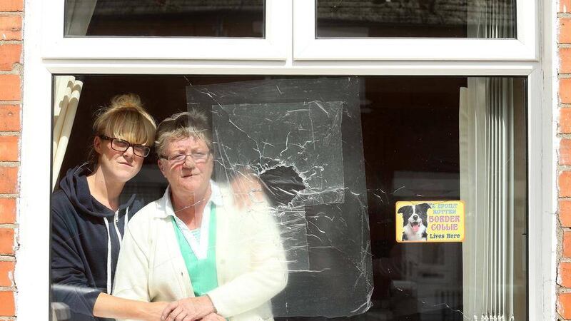 Mary McQuillian and her daughter, also Mary, at the window of their Rodney Drive home that was attacked by gunmen in the early hours of Tuesday morning. Picture by Mal McCann 