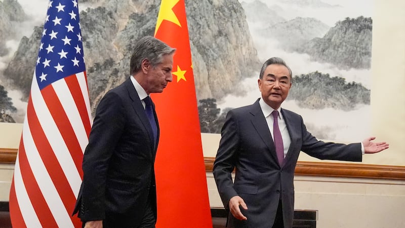 China’s foreign minister Wang Yi, right, gestures to US secretary of state Antony Blinken at the Diaoyutai State Guesthouse in Beijing, China (Mark Schiefelbein, Pool/AP)