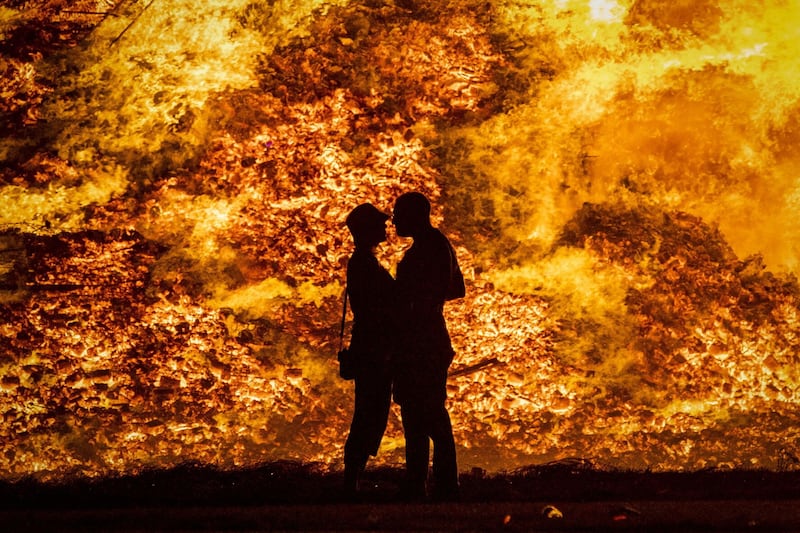 A couple embrace in silhouette at Craigyhill loyalist bonfire in Larne,