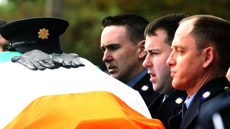 The coffin of Garda Tony Golden is carried into St Oliver Plunkett Church, in Blackrock, Co Louth for his state funeral 
