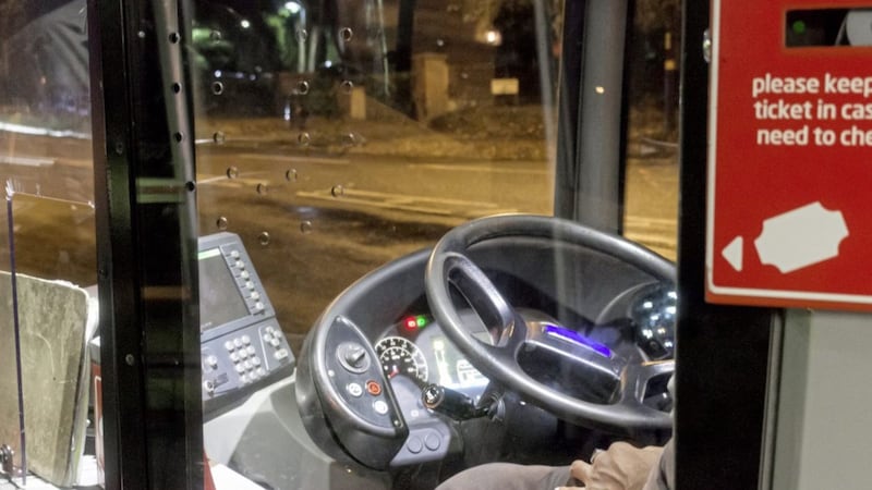Bus driver sitting in bus cab 