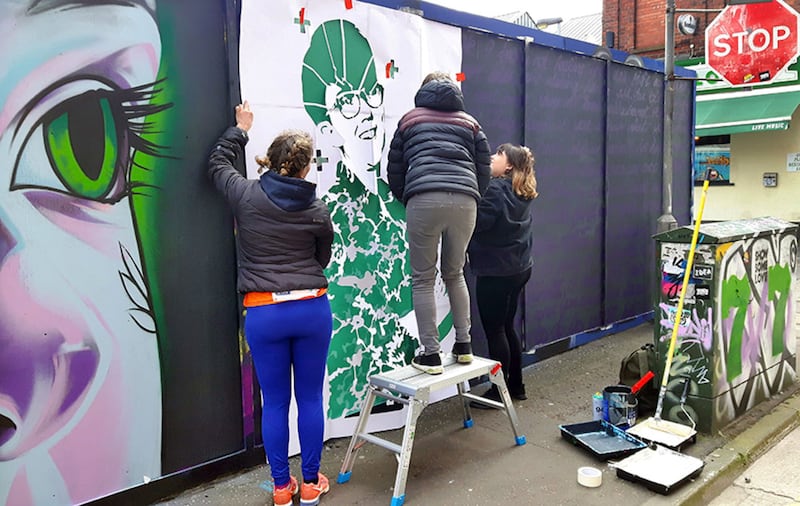 &nbsp;Graffiti artists working on a picture of murdered journalist Lyra McKee in Kent Street, Belfast. Picture by Cliff Donaldson