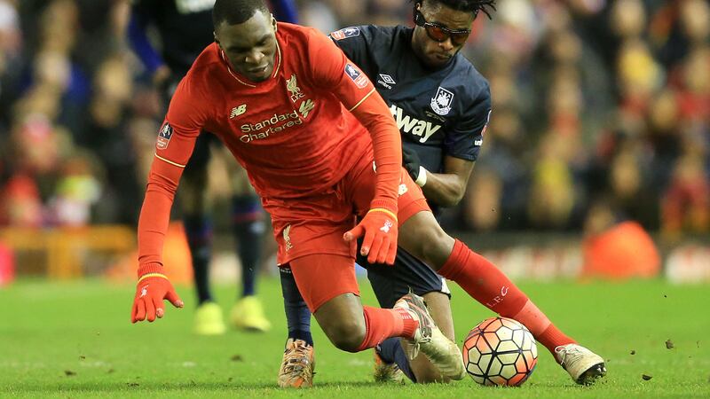 Liverpool's Christian Benteke (left) and West Ham's Alex Song in action during the Emirates FA Cup, fourth round match at Anfield