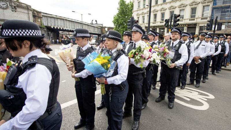 Police officers arrive to lay flowers on London Bridge near to the scene of Saturday's terror attack at London Bridge <br />PICTURE: Dominic Lipinski/PA