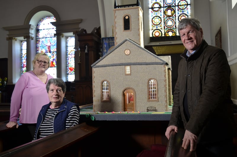 Joyce Stafford and Hilary Keys proudly display the replica of St macCartan Cathedral that their Knit, Stitch and Natter group knitted